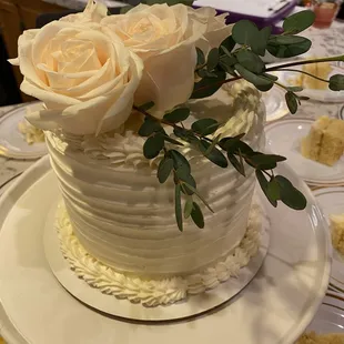 a wedding cake with roses on top