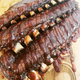Lychee wood smoked pork spareribs with house honey bourbon BBQ sauce.