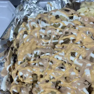 Loaded Waffles fries, topped with Mac &amp; cheese, chicken strips and 3 types of house sauce.