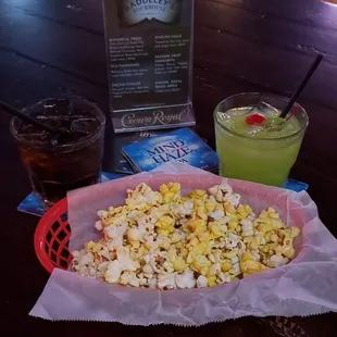 a tray of popcorn and a drink