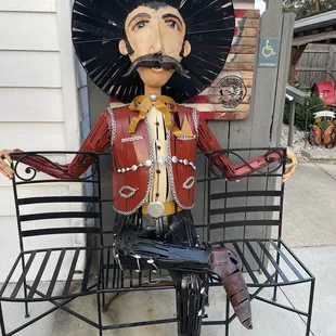 a statue of a man sitting on a bench