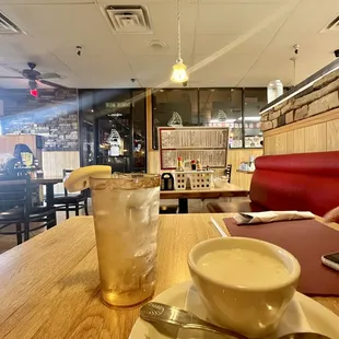 a cup of coffee and a spoon on a table