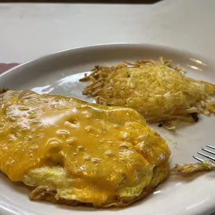 a plate of eggs and hash browns