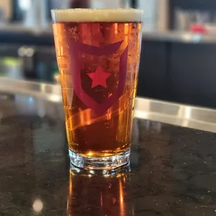 a pint of beer on a bar