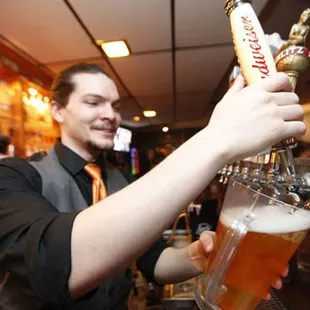 a bartender pouring a beer