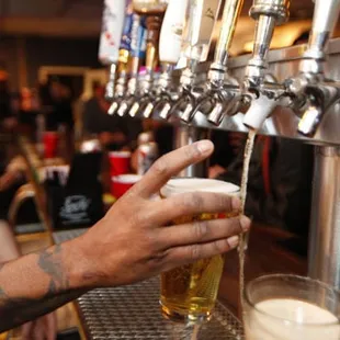 a man filling a pint of beer