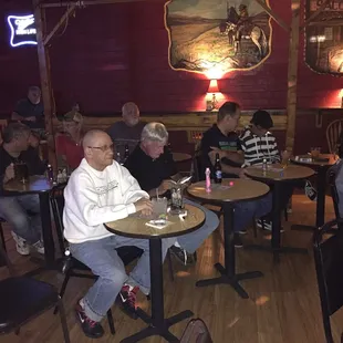 people sitting at tables in a restaurant