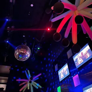 a disco scene with disco lights and balloons