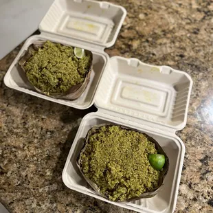 three trays of food sitting on a counter