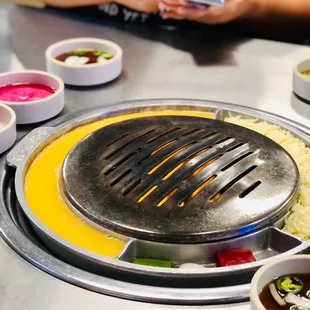 Eggs and cheesy corn cooking on the sides