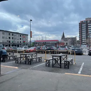a parking lot with tables and benches