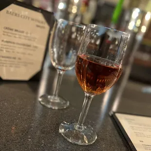 two wine glasses on a bar