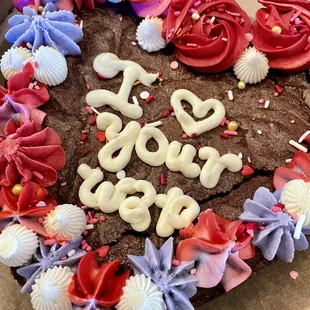 a chocolate cake with frosting and sprinkles