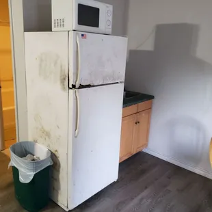 Fridge is all jacked up and old, but it does work. Microwave is old school too but again does work.