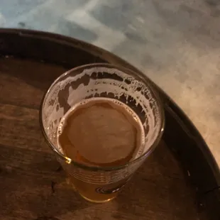 a glass of beer on a barrel