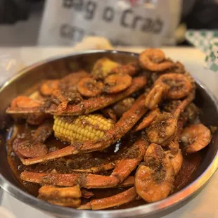 a bowl of cooked shrimp and corn