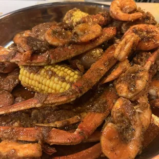 a plate of crab legs and corn on the cob