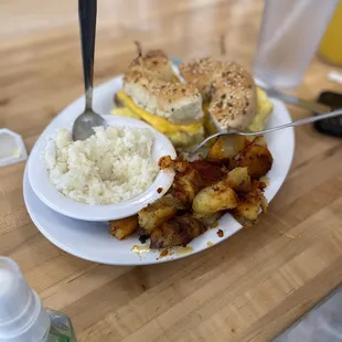 Bagel sandwich, grits and potatoes