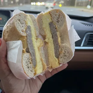 a person holding a sandwich in their hand