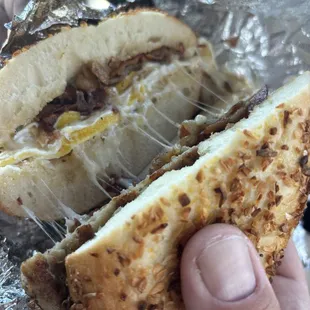 Sausage, bacon, Swiss, and two eggs on an onion roll