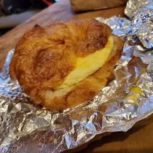 Omelette sandwich with turkey bacon on a croissant