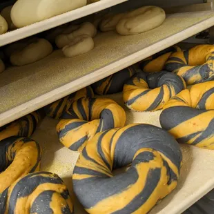 a person holding a tray of bagels