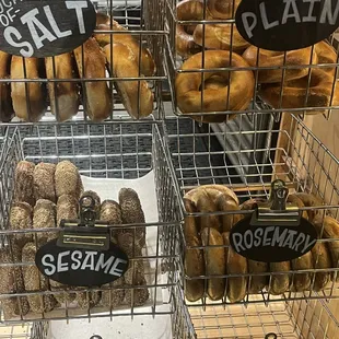 a variety of bagels in wire baskets