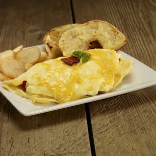 This delicious omelet is served with cottage fries and half of a toasted and buttered bagel. Delicious!