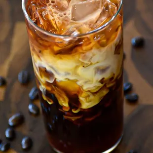 a glass of iced coffee on a table