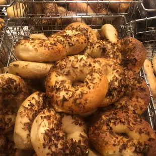 a variety of bagels in a wire basket