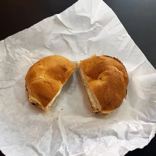 a half eaten sandwich on a piece of paper