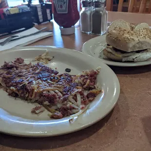 Corn beef hash up front, bagel sandwich in back
