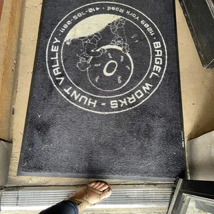 a person standing in front of a doormat