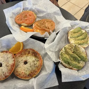 Pizza bagel, tomato lemon pepper special and bagel w cream cheese avocado and lemon pepper.