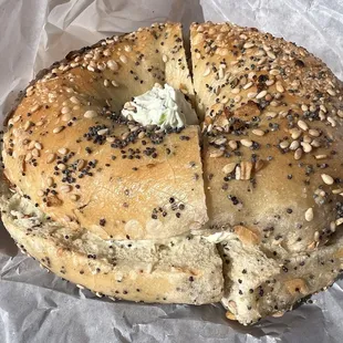 a bagel with seeds and butter