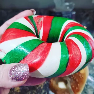 a hand holding a candy cane