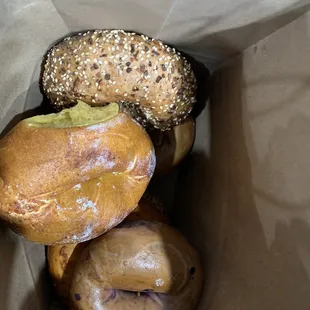 a variety of donuts in a paper bag