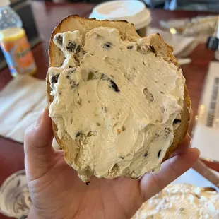Salt bagel with olive cream cheese