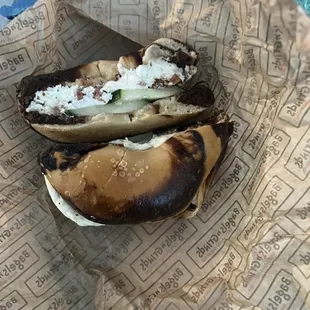 Breakfast sandwich on black and white bagel.