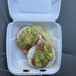 two sandwiches in a styrofoam container