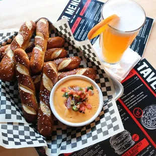 a basket of pretzels and a glass of beer