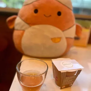 a cup of tea and a stuffed animal