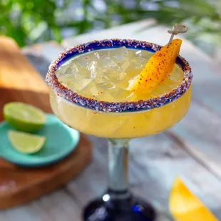 Hot Honey Mango Margarita - Casamigos Reposado Tequila, mango, hot honey and bitters with a sweet and spicy rim
