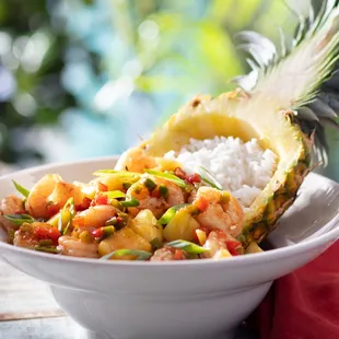 Shrimp Pineapple Bowl - Sautéed shrimp, white rice, diced pineapples and sweet peppers tossed in a jerk pineapple glaze.