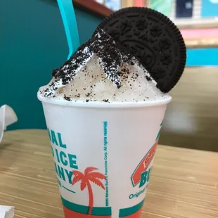 a cup of ice cream with a cookie on top