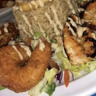Grilled &amp; fried shrimp over rice and salad  W/ tahini sauce drizzled on top .   -A1 since Day1