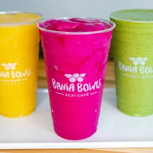 three smoothie drinks on a tray