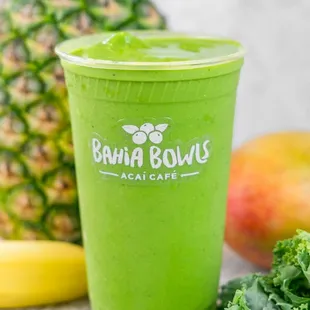 a green smoothie and a pineapple