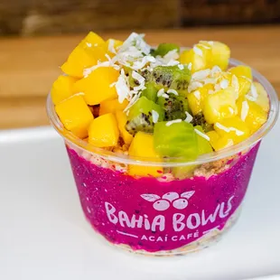 a fruit smoothie in a plastic cup