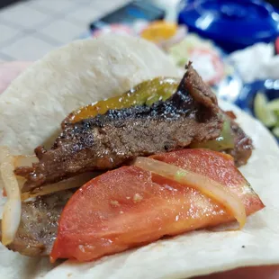 a hand holding a taco